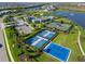 Aerial view features tennis and basketball courts, offering residents diverse recreational activities and promoting a healthy lifestyle at 7928 Redonda Loop, Bradenton, FL 34202