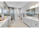 Elegant bathroom with a glass enclosed shower, soaking tub, and dual vanities at 7928 Redonda Loop, Bradenton, FL 34202