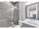 Modern bathroom featuring tiled shower with glass doors, vanity with sink, and gray and white color scheme at 7928 Redonda Loop, Bradenton, FL 34202