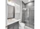 Modern bathroom featuring tiled shower with glass doors, vanity with sink, and gray and white color scheme at 7928 Redonda Loop, Bradenton, FL 34202