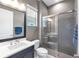 Modern bathroom with a glass-enclosed shower, vanity with a sink, and sleek finishes at 7928 Redonda Loop, Bradenton, FL 34202