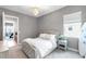 Bright bedroom with a window view, complemented by a decorative chandelier, rug, and comfortable bed at 7928 Redonda Loop, Bradenton, FL 34202