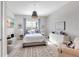 Bedroom with a striped bed, white dresser, blue curtains, and nautical decor at 7928 Redonda Loop, Bradenton, FL 34202