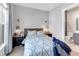 Comfortable bedroom featuring a serene color scheme, accent lighting, and a doorway to the en suite bathroom at 7928 Redonda Loop, Bradenton, FL 34202
