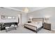 Bedroom with a tufted headboard, elegant chandelier, and cozy seating area at 7928 Redonda Loop, Bradenton, FL 34202