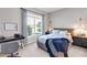 Cozy bedroom showcasing a large window, desk, and comfortable bed, perfect for relaxation and study at 7928 Redonda Loop, Bradenton, FL 34202