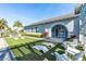 Exterior view features a clubhouse with Adirondack chairs on the lawn, perfect for outdoor relaxation and community gatherings at 7928 Redonda Loop, Bradenton, FL 34202