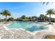 Beautiful community pool and sundeck surrounded by lush landscaping and palm trees at 7928 Redonda Loop, Bradenton, FL 34202