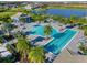 Aerial view of a resort-style pool and lap pool, surrounded by palm trees, creating a relaxing atmosphere for residents at 7928 Redonda Loop, Bradenton, FL 34202