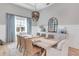 Dining room with a decorative chandelier, light-colored walls, and a large window at 7928 Redonda Loop, Bradenton, FL 34202