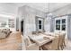 The dining room features a modern chandelier, hardwood floors and adjacent views of the living room at 7928 Redonda Loop, Bradenton, FL 34202