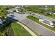 Aerial view showcases the community entrance with lush landscaping, a guardhouse, and water feature, providing a welcoming atmosphere at 7928 Redonda Loop, Bradenton, FL 34202