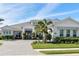 Beautiful home exterior featuring a well-maintained lawn, lush landscaping and a gray tile roof at 7928 Redonda Loop, Bradenton, FL 34202