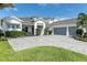 Elegant two-story home with a gray roof, white trim, lush landscaping, and a spacious three-car garage at 7928 Redonda Loop, Bradenton, FL 34202