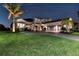 Beautiful home with a well-maintained lawn, palm trees, and a three-car garage at twilight at 7928 Redonda Loop, Bradenton, FL 34202