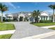 Beautiful home featuring a paved driveway, manicured lawn, and lush landscaping at 7928 Redonda Loop, Bradenton, FL 34202