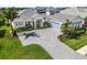 Elegant home featuring a paver driveway, lush landscaping, and a neutral color palette at 7928 Redonda Loop, Bradenton, FL 34202