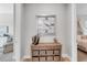 Hallway featuring a wood cabinet, decorative items, and views into other rooms at 7928 Redonda Loop, Bradenton, FL 34202