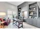 Home office with custom built-ins, a window with natural light, and comfortable seating for work at 7928 Redonda Loop, Bradenton, FL 34202