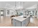 Open-concept kitchen island with seating that overlooks the living room and dining area at 7928 Redonda Loop, Bradenton, FL 34202