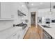 Contemporary kitchen featuring white cabinets, stainless steel appliances, and a functional layout at 7928 Redonda Loop, Bradenton, FL 34202