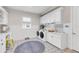 Well-organized laundry room featuring modern appliances, ample storage, stylish flooring, and a desk area at 7928 Redonda Loop, Bradenton, FL 34202