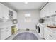 Laundry room with modern appliances, white cabinetry, and workspace for convenience at 7928 Redonda Loop, Bradenton, FL 34202
