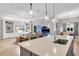 Open-concept living space with a kitchen island, built-in shelving, hardwood floors, and a pool view at 7928 Redonda Loop, Bradenton, FL 34202