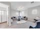 Spacious living room featuring large windows, modern lighting, and access to a full bathroom at 7928 Redonda Loop, Bradenton, FL 34202