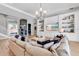 Spacious living room featuring custom built-ins and a modern light fixture at 7928 Redonda Loop, Bradenton, FL 34202