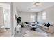 Bright living room featuring a large sectional sofa and modern decor adjacent to a bathroom with a walk-in shower at 7928 Redonda Loop, Bradenton, FL 34202