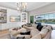 Living area with a large sectional sofa, custom built-ins, and a view of the pool area at 7928 Redonda Loop, Bradenton, FL 34202