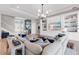 Bright living room with built-in shelving, hardwood floors, and an elegant sectional sofa at 7928 Redonda Loop, Bradenton, FL 34202