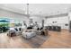 Open-concept living room featuring a modern kitchen, dining area, and access to the pool at 7928 Redonda Loop, Bradenton, FL 34202