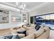 Cozy living room with a built-in entertainment center, stylish furniture, and sliding glass doors to the pool area at 7928 Redonda Loop, Bradenton, FL 34202