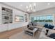 Bright living room with custom built-ins, modern lighting, and sliding glass doors to outdoor pool and patio at 7928 Redonda Loop, Bradenton, FL 34202