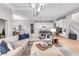 The living room features bright natural light with an open floor plan and views of the kitchen at 7928 Redonda Loop, Bradenton, FL 34202
