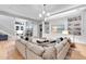 Spacious living room with large sectional sofa, custom built-ins, and bright, natural light at 7928 Redonda Loop, Bradenton, FL 34202