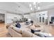 A luxurious living room flows into an open-plan kitchen and offers a large sectional sofa at 7928 Redonda Loop, Bradenton, FL 34202