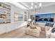 Cozy living room with a built-in entertainment center, stylish furniture, and sliding glass doors to the pool area at 7928 Redonda Loop, Bradenton, FL 34202