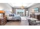 Bright and airy main bedroom with a large bed, dresser, and a stunning chandelier at 7928 Redonda Loop, Bradenton, FL 34202