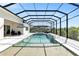 Screened pool area with a spa, lounge chairs, and privacy landscaping at 7928 Redonda Loop, Bradenton, FL 34202