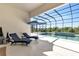 Screened pool area with lounge chairs, umbrellas, and lush landscaping at 7928 Redonda Loop, Bradenton, FL 34202