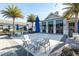Community clubhouse and pool area featuring resort-style seating, tables and palm trees at 7928 Redonda Loop, Bradenton, FL 34202