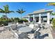 Community clubhouse and pool area featuring resort-style seating, tables and lush landscaping at 7928 Redonda Loop, Bradenton, FL 34202