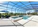 Spacious screened-in pool area with spa, lounge chairs, and outdoor dining at 7928 Redonda Loop, Bradenton, FL 34202