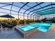 A stunning indoor pool and hot tub overlook the landscape at dusk from this luxury home at 7928 Redonda Loop, Bradenton, FL 34202