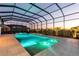Stunning screened-in pool area with a sparkling pool, relaxing lounge chairs, and lush landscaping at 7928 Redonda Loop, Bradenton, FL 34202