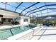 Inviting screened-in pool and spa with sun shelf and lounge chairs at 7928 Redonda Loop, Bradenton, FL 34202