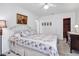 Bright bedroom featuring a bed with floral bedding, a closet with wood and an adjacent door at 804 33Rd Street W Ct, Bradenton, FL 34205